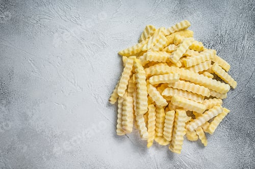 Preview: Frozen Crinkle French fries potatoes sticks. White background. Top view. Copy space