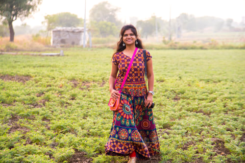 Preview: Young girl walking in chickpea field