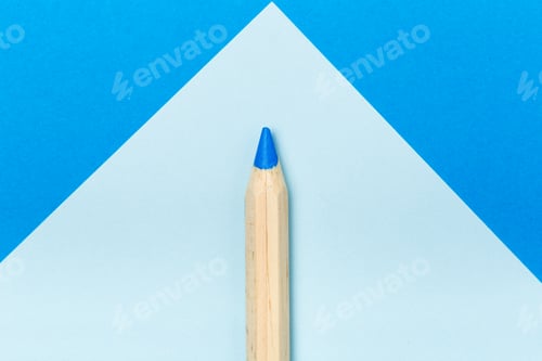 Preview: Bright blue pencil placed against blue geometric background shows art supplies and creativity