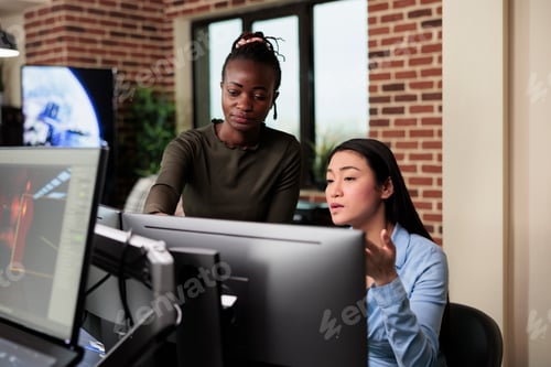 Preview: Asian developer and african american colleague developing digital art using modelling software.