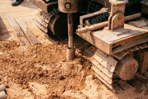 Preview: Close shot of a heavy machine digging the ground at daytime