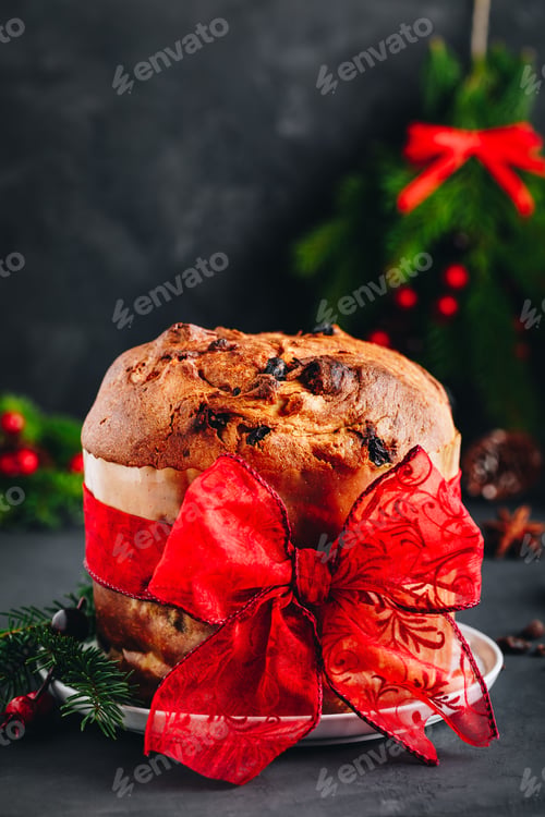 Preview: Traditional Christmas Panettone cake with dried fruits decorated with a red ribbon