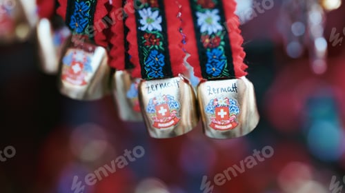 Preview: Colorful souvenirs from Zermatt, Switzerland featuring traditional bells and decorative ribbons