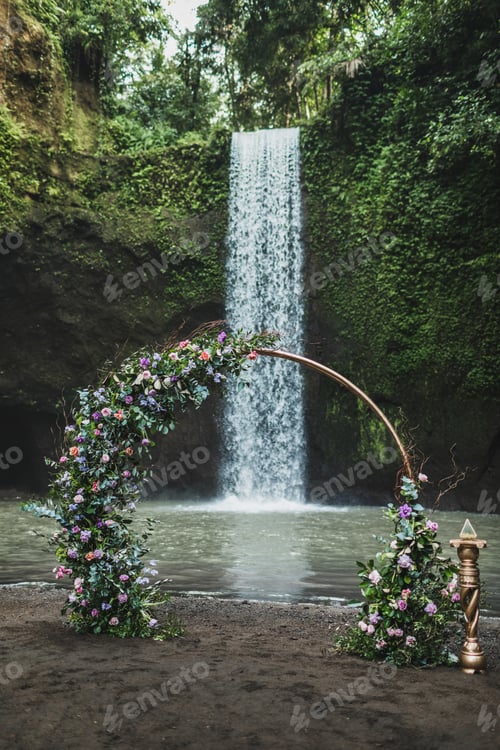 Preview: Round metal wedding arch decorated with purple and green flowers on Tibumana waterfall