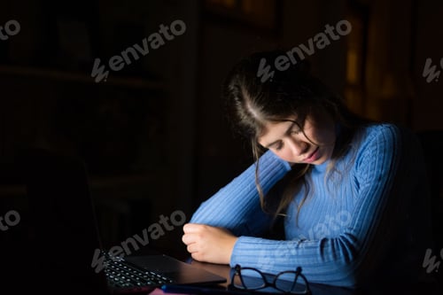Preview: One tired and exhausted young woman feeling pain in her neck muscles after being working till late