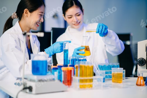 Preview: Two female biotechnologists testing new chemical substances in a laboratory.