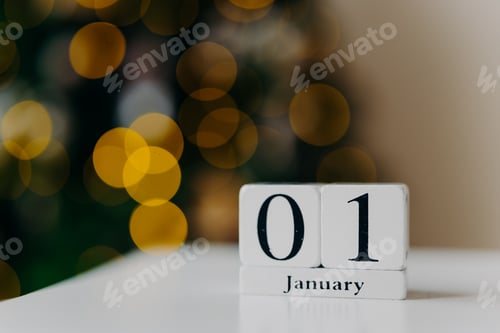 Preview: Calendar with numbers and month on white desk against shing lights and New Year background