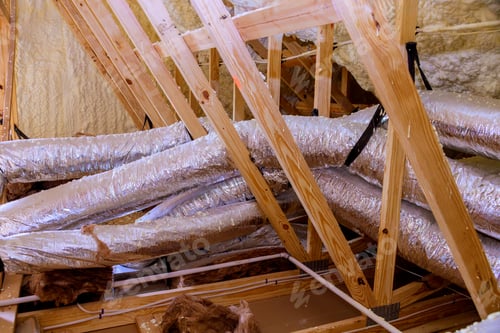 Preview: Insulated attic with exposed ductwork wooden beams during home renovation process