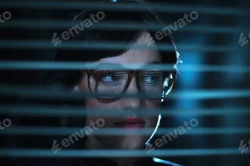 Preview: Mysterious Retro 1980S Business Woman In Glasses Looking Through Blinds.