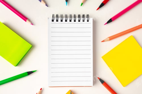 Preview: Top view of school supplies, pencils and notepad