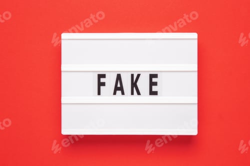 Preview: Lightbox with word fake on red background. Business, fake and fact concept.