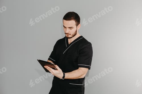 Preview: Portrait of a friendly doctor. Isolated on gray