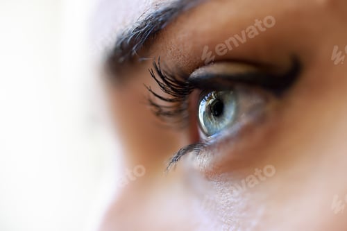 Preview: Close-up of young woman's blue eyes with long eyelashes