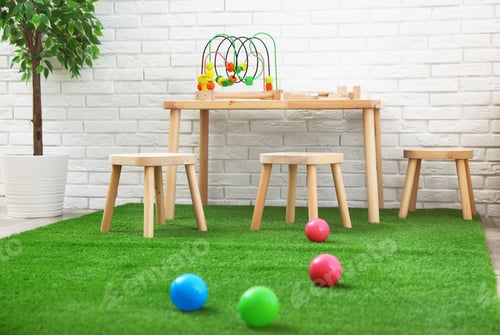 Preview: Stylish playroom interior with toys and modern wooden furniture
