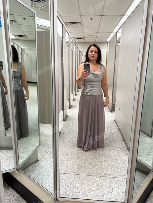 Preview: Woman trying on a dress.