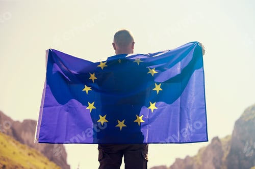 Preview: Man with EU flag over blue sky