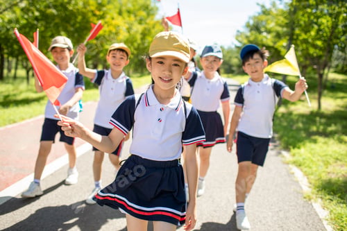 Preview: Cheerful Chinese school children relaxing in park