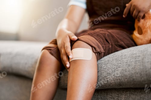 Preview: Child with plaster or bandaid, injured and hurt by accident while playing a sport, exercise or outs