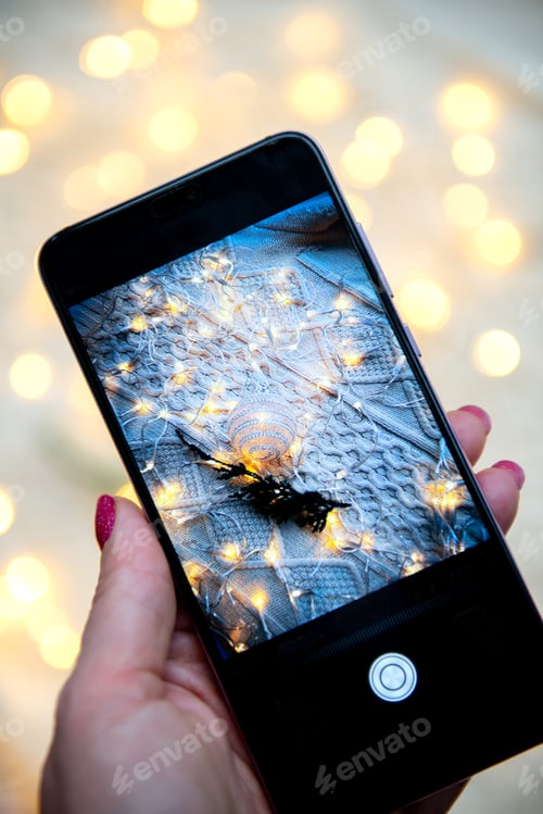 Preview: christmas ornament in mobile phone camera, warm light bokeh background