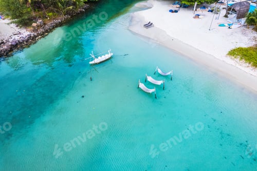 Preview: Koh Kood Island with cradle, boat in turquoise sea by the beach in summer