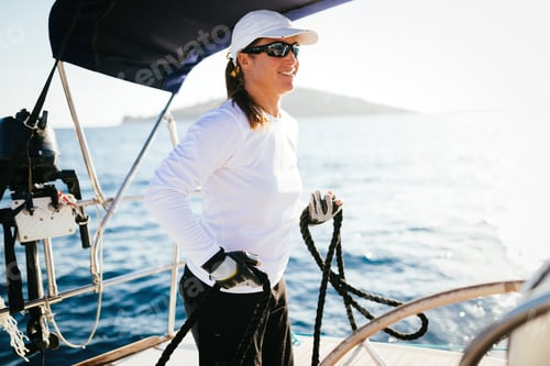 Preview: Attractive strong woman sailing with her boat