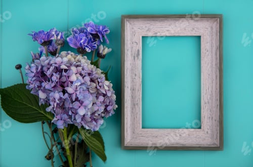 Preview: top view of fresh wonderful flowers such as daisy and gardenzia on a blue background with copy space