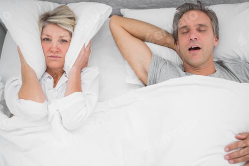 Preview: Man Snoring Loudly As Partner Blocks Her Ears At Home In Bedroom