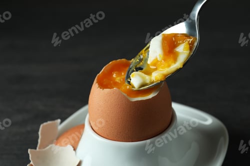 Preview: Concept of tasty breakfast with boiled egg on dark wooden table