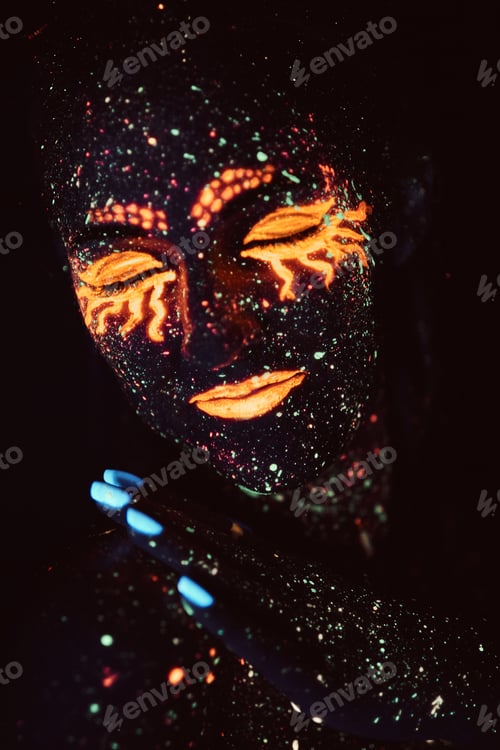 Preview: Portrait of a girl painted in fluorescent powder. Halloween concept.