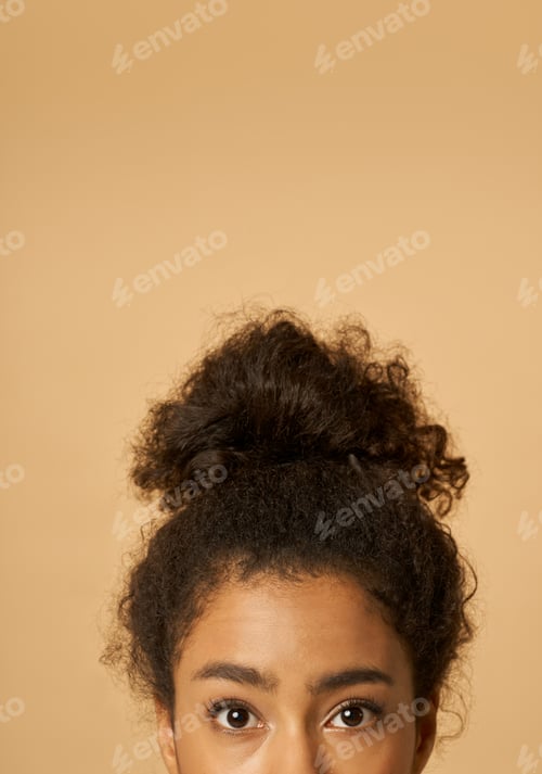Preview: Young Woman with Curly Dark Hair in Bun