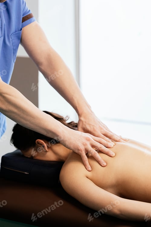 Preview: Physiotherapist giving backstroke therapy to a woman