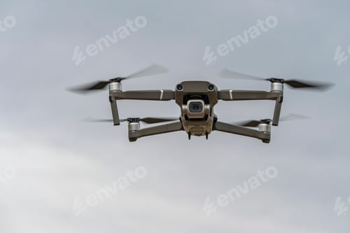 Preview: Professional quadcopter flying high in the gray sky