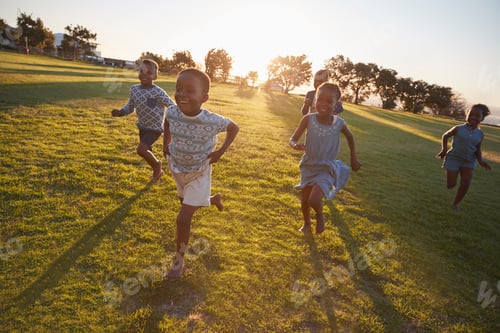 Preview: Elementary school kids running to camera in an open field