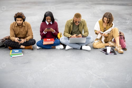 Preview: Students with digital devices sitting on asphalt