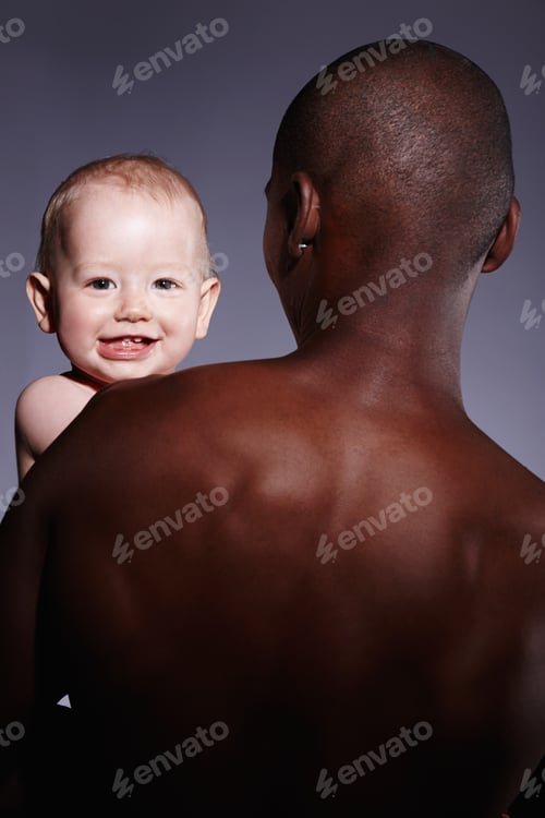 Preview: Safe and secure in his arms. Portrait of a cute little boy being held by an adult male.