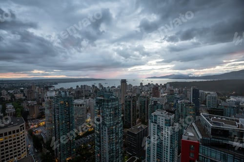 Preview: Aerial view of Downtown City during a stormy summer sunset