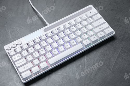 Preview: Modern white keyboard with RGB lighting on grey table