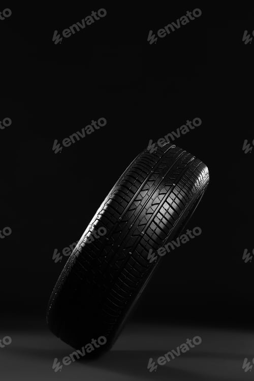 Preview: New car tire on black background