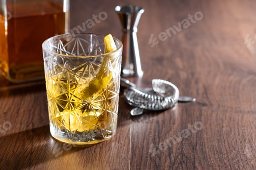 Preview: Rusty Nail Cocktail with Lemon Peel in Crystal Glass