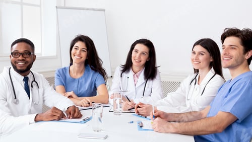 Preview: Young interns listening to professor in conference room