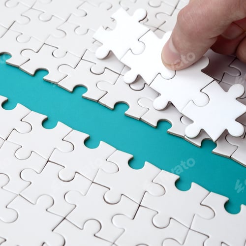 Preview: The human hand paves the way to the surface of the jigsaw puzzle, forming a blue space