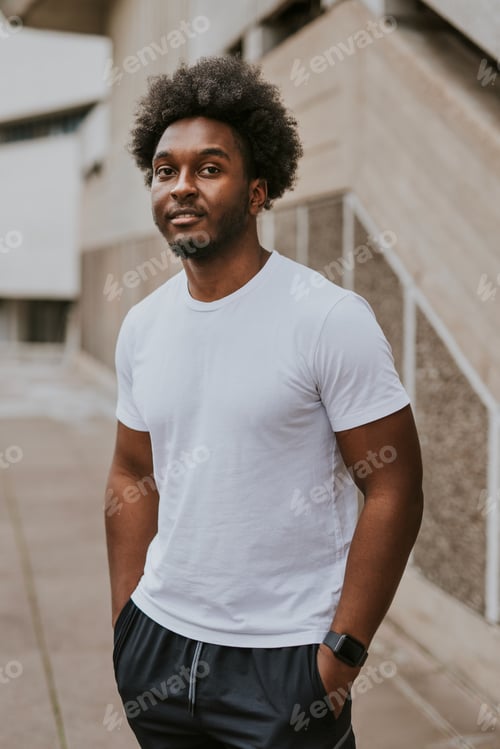 Preview: Cool man in plain whit tee, standing by stairs