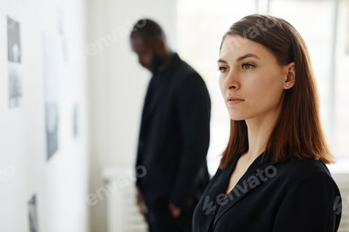 Preview: Woman Looking at Photos in Art Gallery