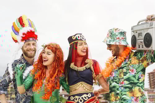 Preview: Happy friends celebrating carnival party outdoor