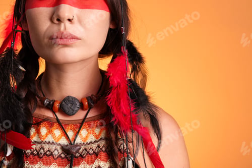 Preview: Shaman woman with tribal accessories on orange gradient background, closeup. Space for text