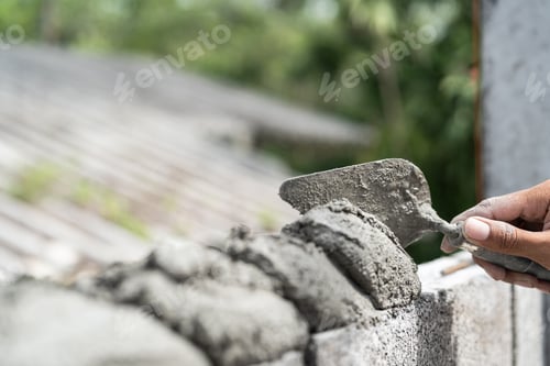 Preview: Hand worker masonry brickwork trowel construction site wall concrete background