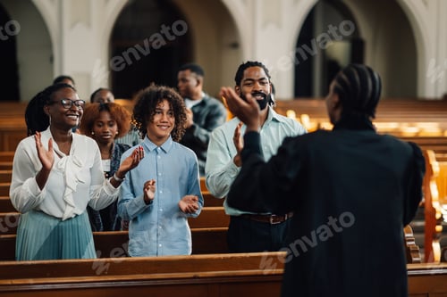 Preview: Congregation clapping along with preacher in church
