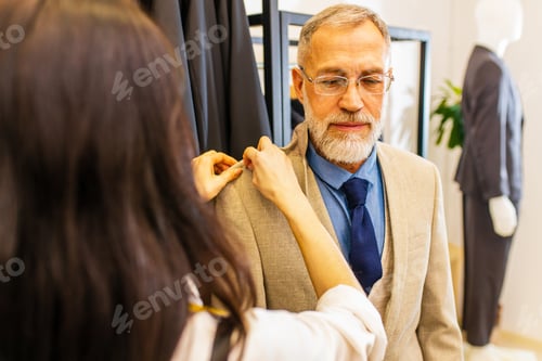 Preview: well-dressed bearded mature handsome client man with atelier master in studio
