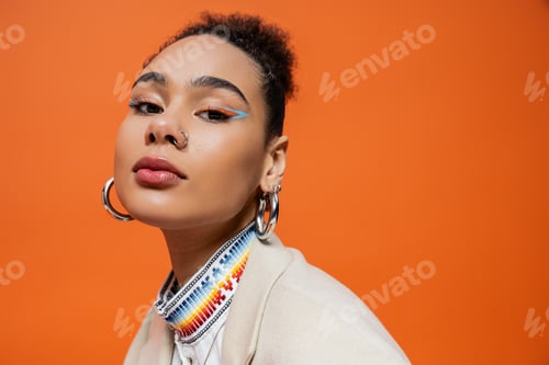 Preview: Woman with Bold Eye Makeup Posing in Studio