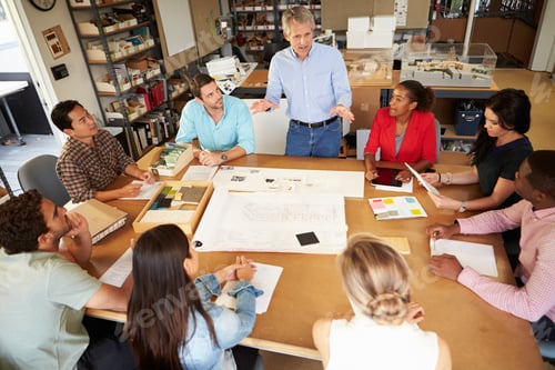 Preview: Group Of Architects Sitting Around Table Having Meeting